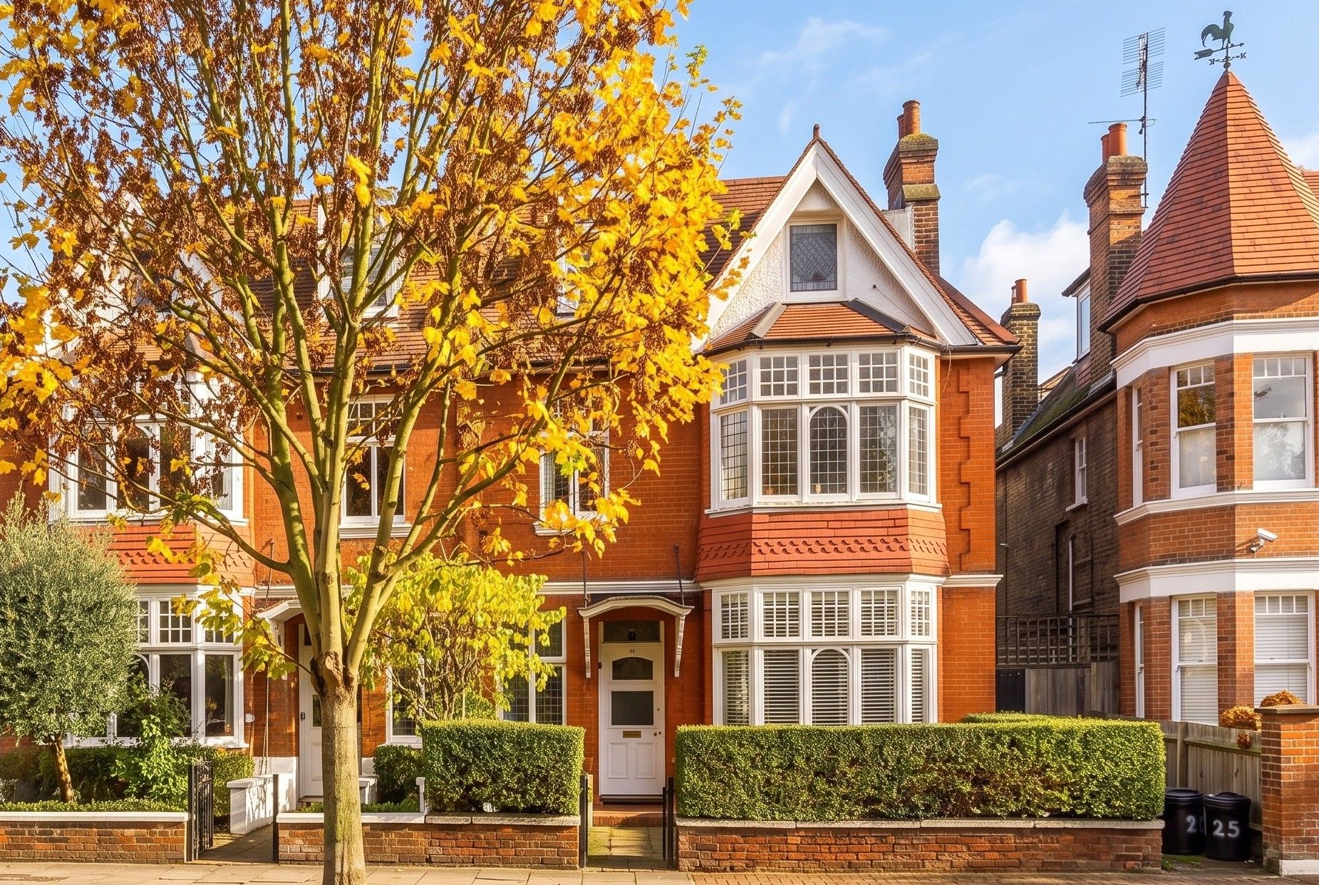 Image of a semi detached property on a bright autumn day with orange leaves on the tree in front