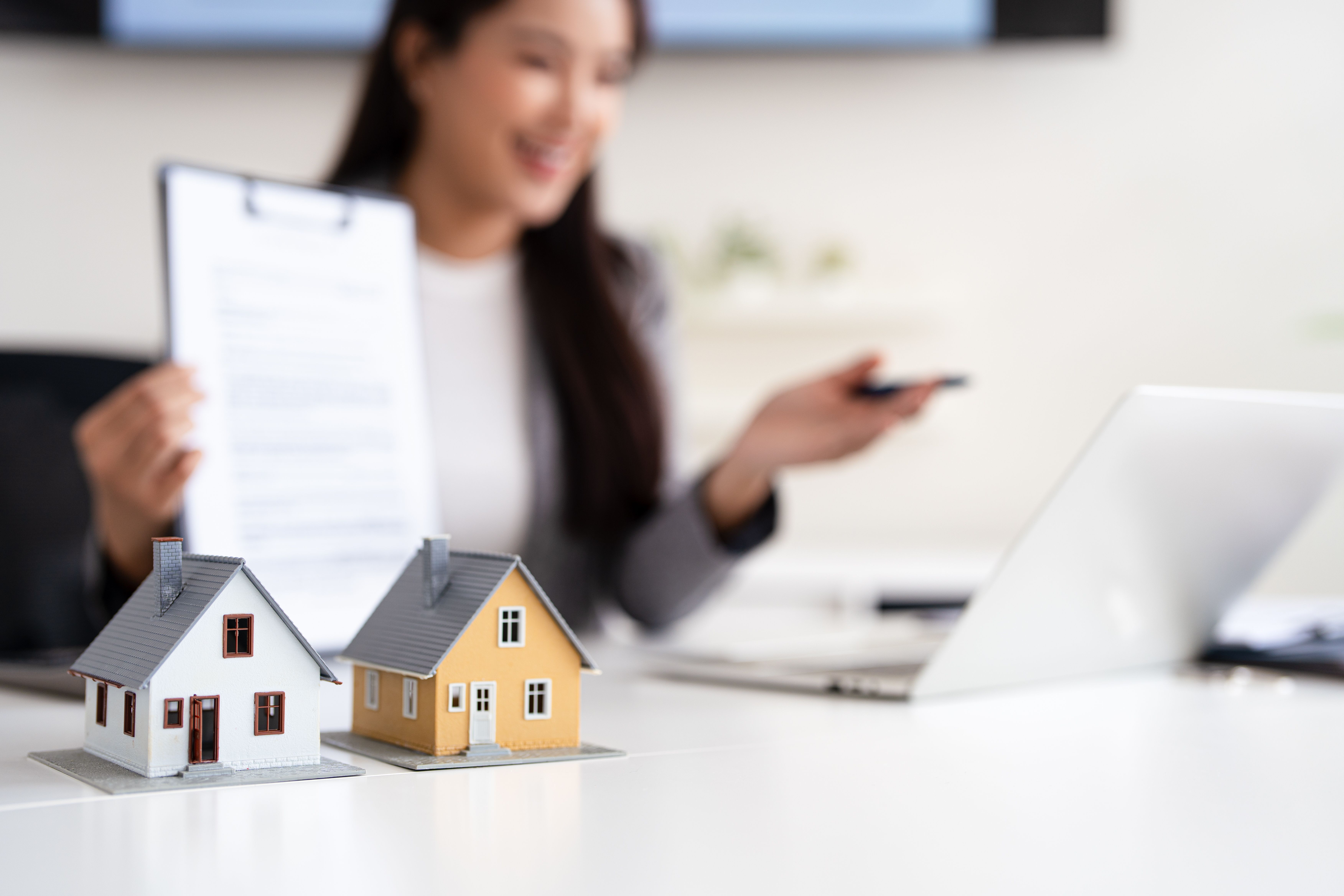 Conveyancer speaking to a client online and talking them through the paperwork for selling their home. 