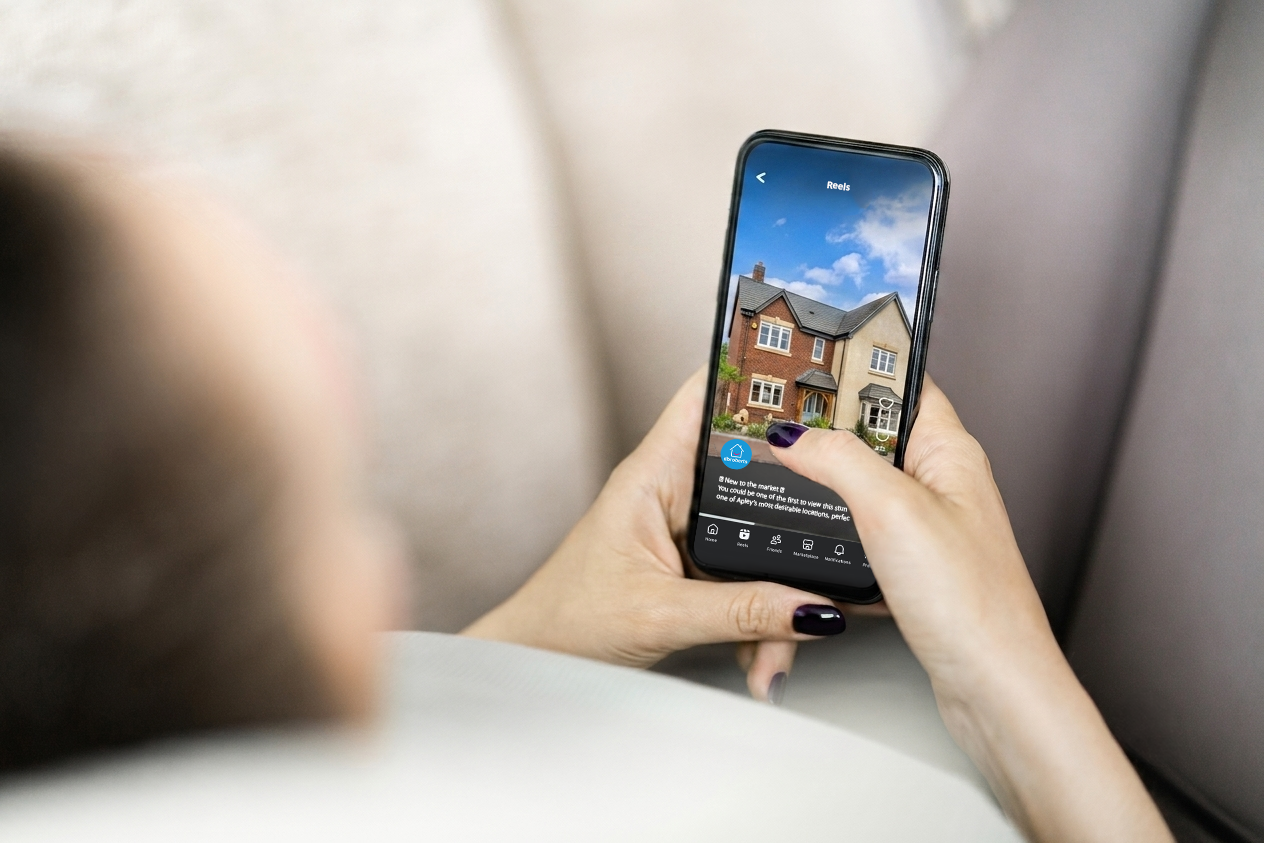 Person watching a featured property video on social media